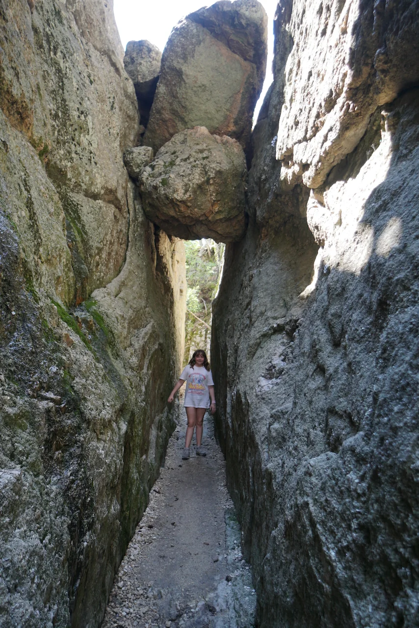 Lily squeezing through the granite formations at Sylvan Lake