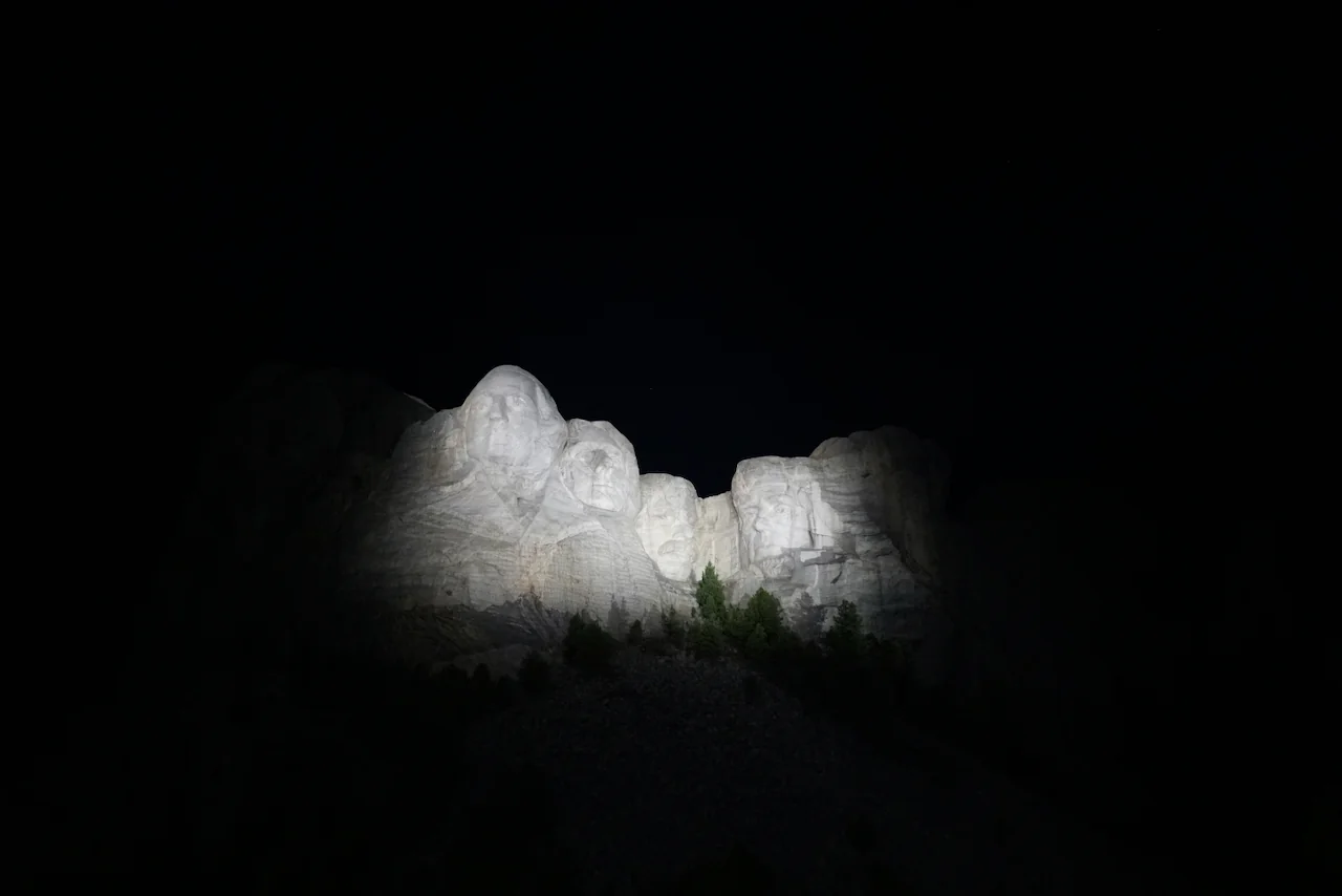 Mount Rushmore illuminated at night